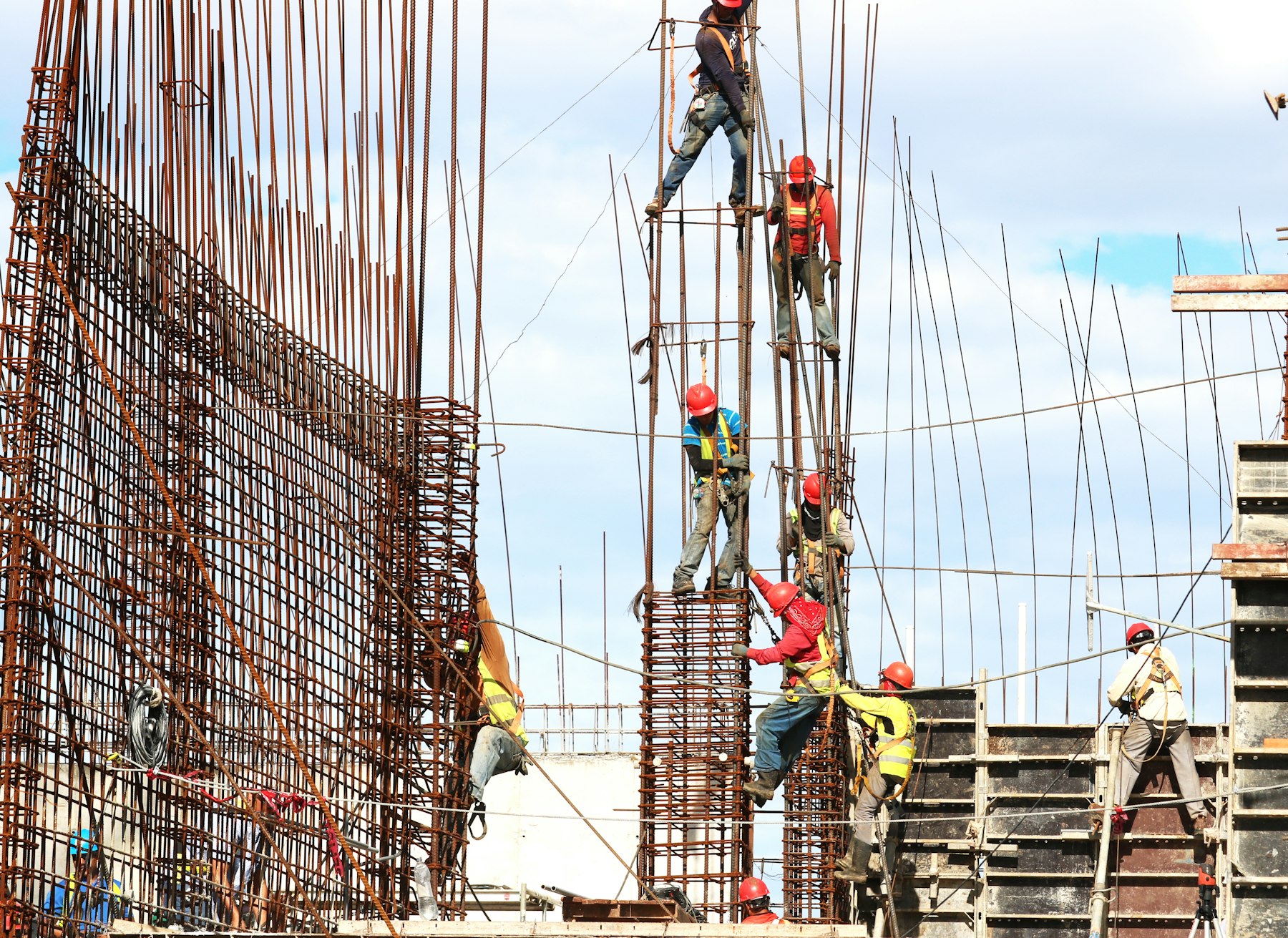 Crews tying rebar columns on an active construction site