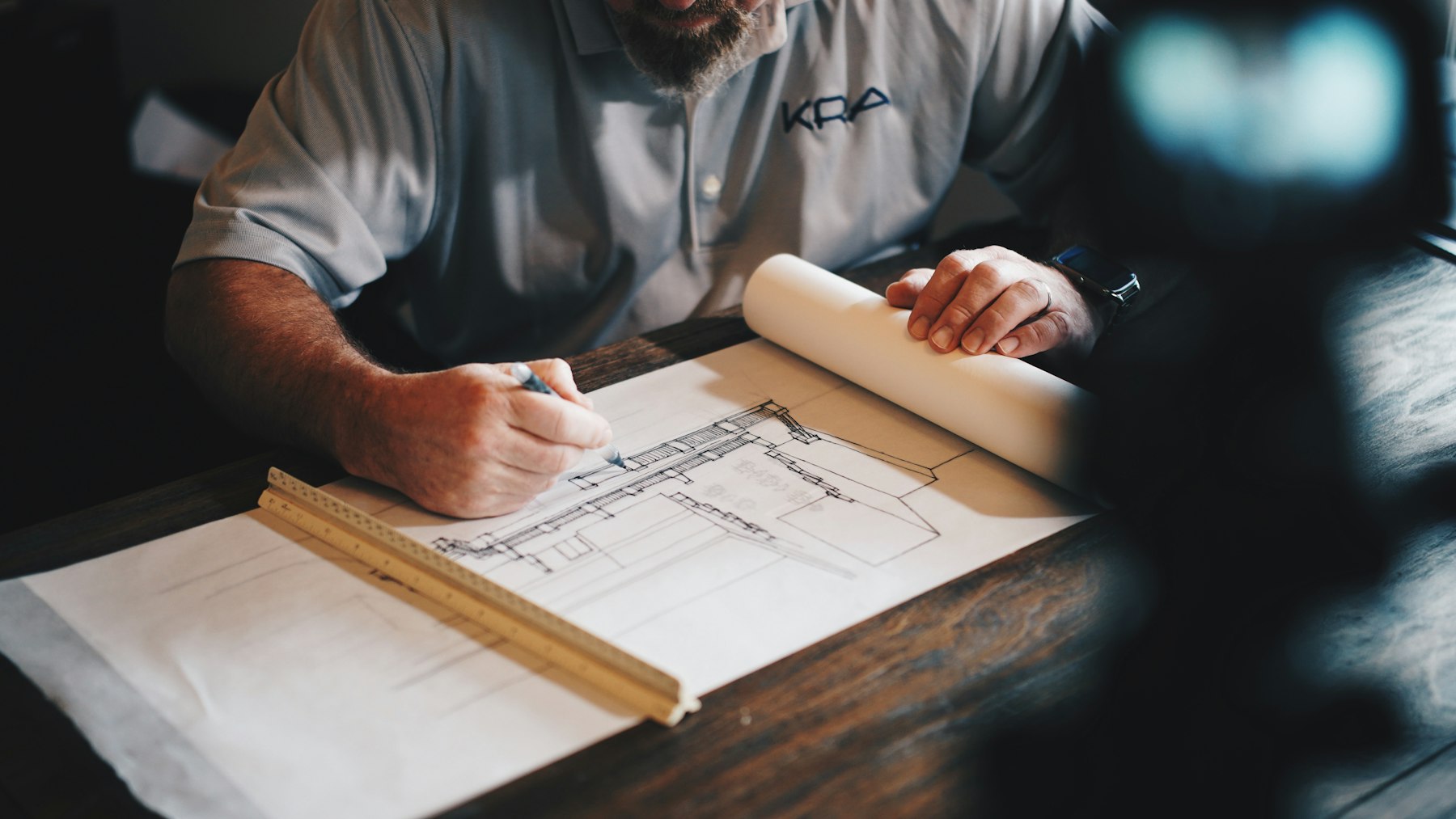 Architect drafting a building plan by hand